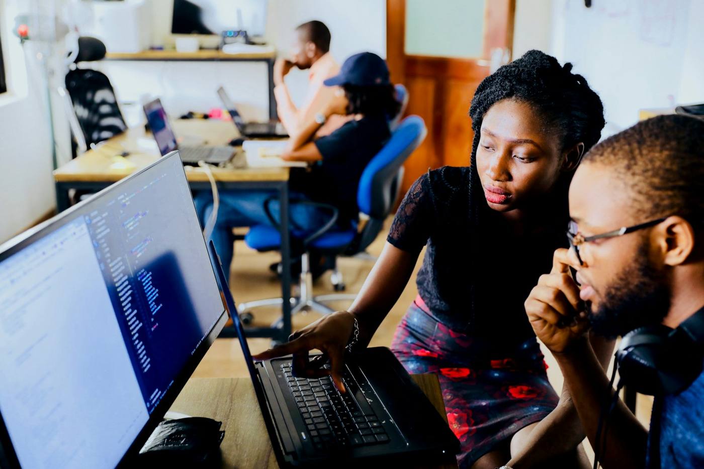 Two Caribbean professionals working through a problem together